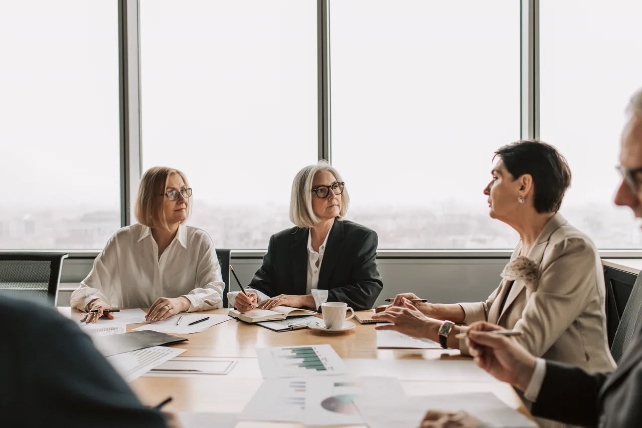 Senior executives in a meeting at a boardroom table