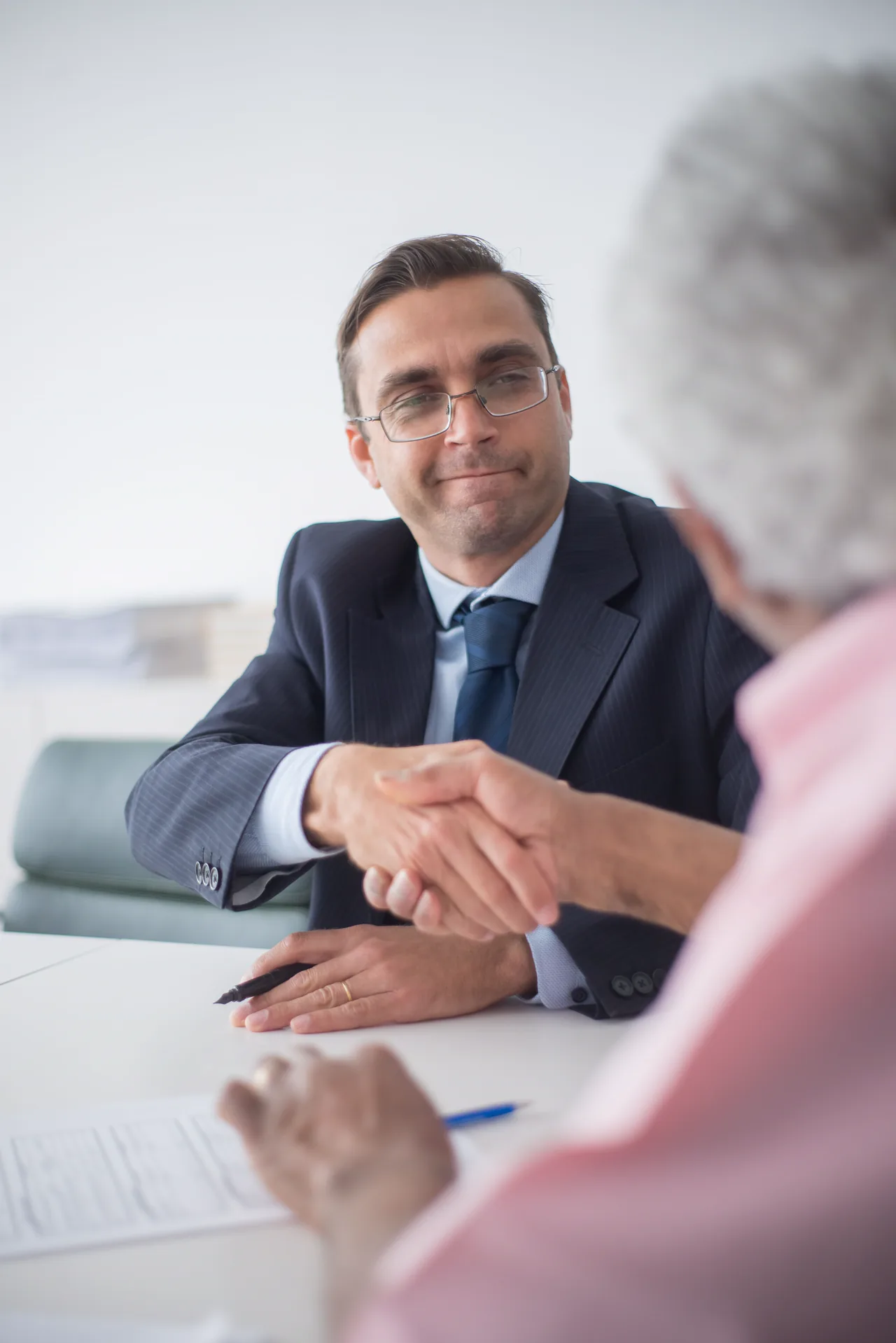 An attorney in a navy suit with a client